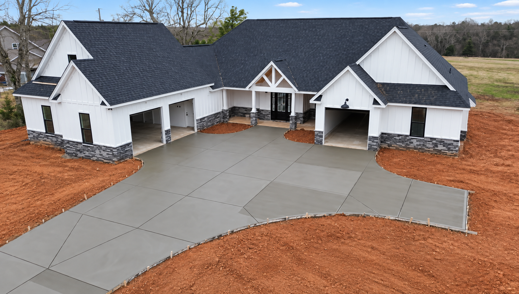 modern white farmhouse with concrete driveway built by Gold C Builders in Denver NC