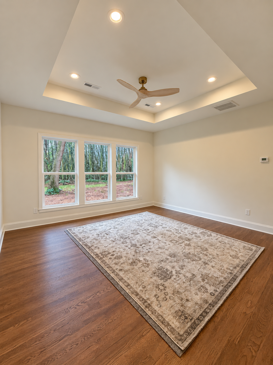 bedroom with coffered ceiling and windows built by Gold C Builders near Lake Norman NC